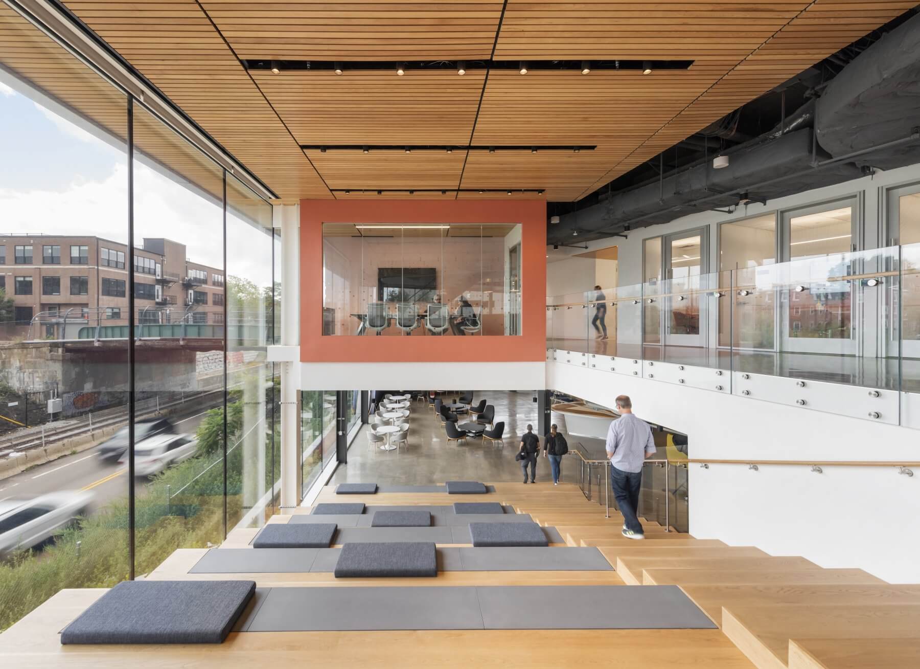 lobby stairs with glass wall and seating next to stairs