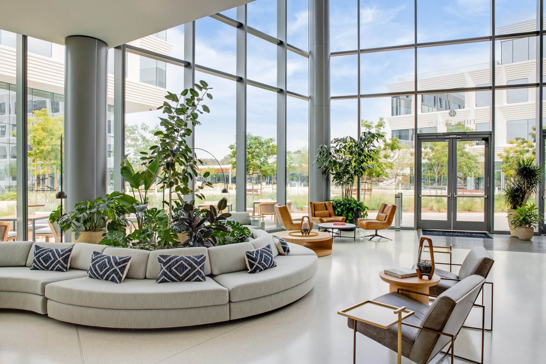 building interior with circular gray couch and chairs